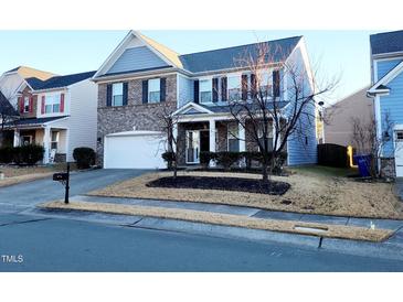 Two-story brick home with gray siding, two-car garage, and landscaping at 302 Glenview Ln, Durham, NC 27703
