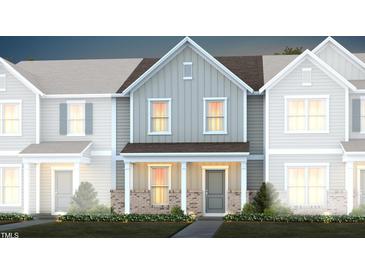 Two-story townhome with gray siding, brick accents, and landscaping at 365 Fosterton Cottage Way, Raleigh, NC 27603