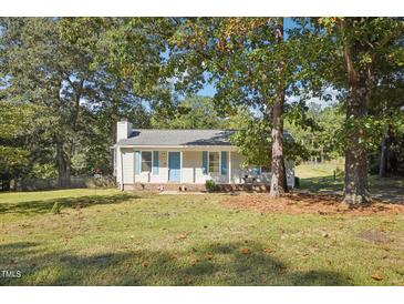 Charming one-story house with a well-manicured lawn and mature trees at 105 N Bend Dr, Knightdale, NC 27545
