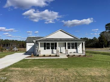Newly built home with front porch and landscaped lawn at 16 Holly Grove Ln, Lillington, NC 27546