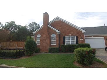Brick home with deck and landscaped yard at 2004 Clyde Bank Ct, Cary, NC 27511