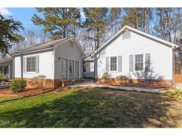 Gray house with a brick base and landscaped lawn at 316 Trappers Run Dr, Cary, NC 27513
