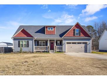 Gray and red two-story house with attached garage and front porch at 10080 Nc-39, Middlesex, NC 27557