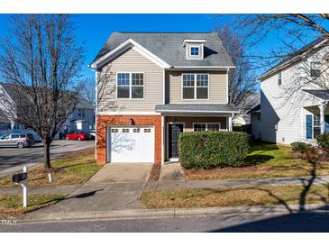 Two-story townhome with brick accents and attached garage at 105 Danesway Dr, Holly Springs, NC 27540