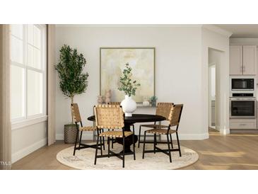 Bright dining area with round table and four chairs, ideal for Gathering meals at 1528 Goldfinch Perch Ln, Knightdale, NC 27545