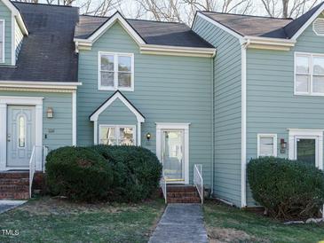 Front view of charming townhome with brick steps and well-manicured landscaping at 431 Oak Run Dr, Raleigh, NC 27606