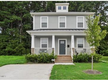 Two-story Craftsman home with gray siding, front porch, and landscaped lawn at 438 S Hillsborough St, Franklinton, NC 27525