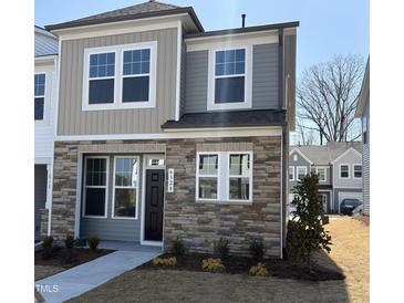 Charming townhome with stone facade, dual siding and meticulous front yard landscaping at 6328 Granite Quarry Dr, Raleigh, NC 27610