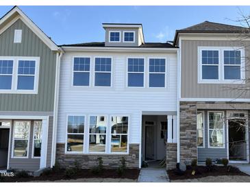 Charming townhome showcases stone accents and light-filled windows on a sunny day at 6330 Granite Quarry Dr, Raleigh, NC 27610