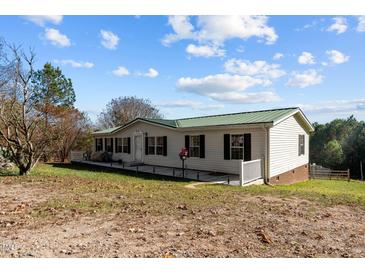 Single-story home with green roof and deck at 754 Firestone Ln, Sanford, NC 27330