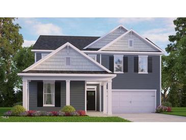 Two-story home with gray siding, two-car garage, and landscaping at 7584 Percussion Dr, Apex, NC 27539