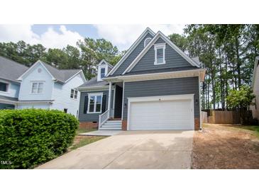Gray house with white garage door and brick accents at 105 Tracey Creek Ct Ct, Apex, NC 27502