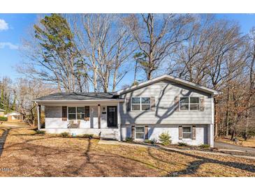 Charming ranch home with gray siding, brick accents, and a spacious front yard at 420 W 10Th St, Siler City, NC 27344