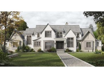 Stunning two-story home with a brick and shingle exterior, large windows, and a walkway at 432 Firefly Overlook, Pittsboro, NC 27312