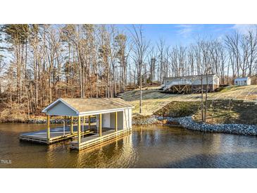 Lakefront home with boathouse and private dock; wooded lot at 261 Willifords Pt Dr, Roxboro, NC 27574
