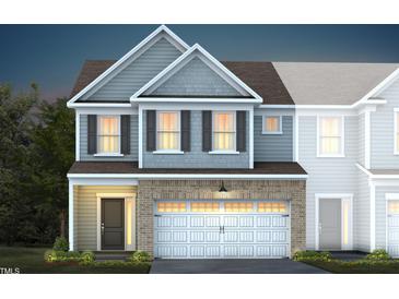 Two-story townhome with gray and white siding, and a two-car garage at 287 Broomside Ave, Raleigh, NC 27603