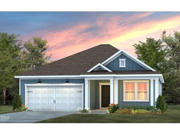 Charming craftsman style home with white and blue exterior, landscaping, and a two-car garage at 341 Broomside Ave, Raleigh, NC 27603