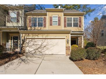Tan two-story townhome with a double-car garage and landscaping at 320 Westgrove Ct, Durham, NC 27703