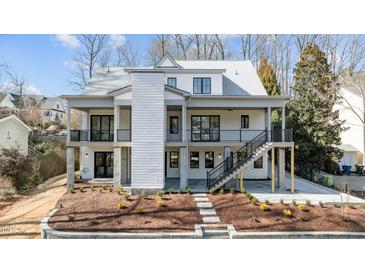 Stunning two-story home featuring a modern design with balconies and landscaped front yard at 3304 Cheswick Dr, Raleigh, NC 27609