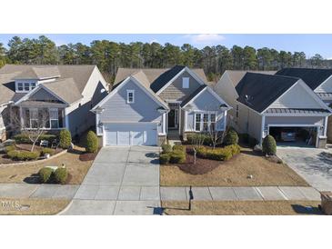 Gray two-story house with a two-car garage and manicured landscaping at 821 Blackfriars Loop, Cary, NC 27519