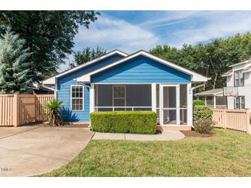 Charming blue house with screened porch and well-manicured lawn at 105 Cooke St, Raleigh, NC 27601