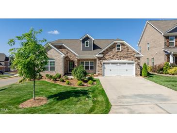 Brick house with a two-car garage and landscaped front yard at 257 Macallan Dr, Burlington, NC 27215