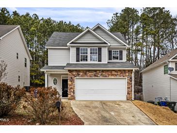 Two-story house with gray siding, stone accents, and a two-car garage at 2730 Erinridge Rd, Raleigh, NC 27610