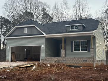 New construction home with gray siding, brick accents and a two-car garage at 5394 Salem Woods Dr # 16, Graham, NC 27253