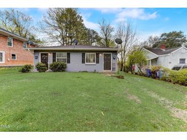 Gray duplex home with two separate entrances and well-maintained lawns at 830 E Lenoir St, Raleigh, NC 27601