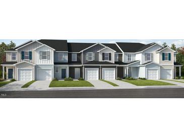 Front view of charming townhouses with attached garages and well-manicured lawns at 128 Parker Ln, Mebane, NC 27302