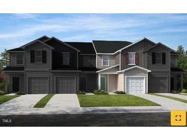 Two-story townhome with gray siding, black roof, and two-car garage at 138 Parker Ln, Mebane, NC 27302