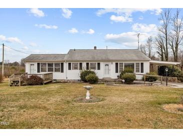 Ranch house with white siding, front porch, and a spacious yard at 1100 Ben Smith Road Rd, Siler City, NC 27344