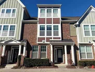 Brick front exterior of charming townhome with multiple windows and landscaping at 549 Balsam Fir Dr Dr, Cary, NC 27519