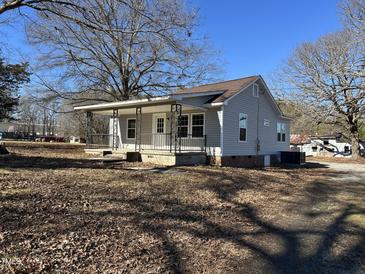 Cute cottage with front porch and mature trees at 808 E Hanover Rd, Graham, NC 27253