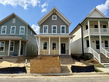 Charming new construction home with a welcoming front porch and a classic architectural style at 1552 Piney Falls Dr, Wendell, NC 27591