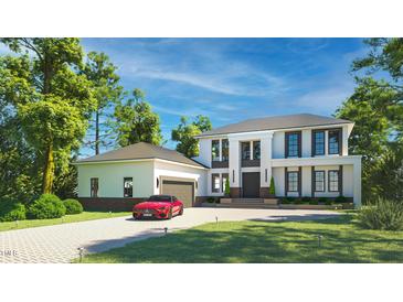 Stunning two-story home featuring a private driveway, black framed windows and a two-car garage at 180 Bur Oak Ct, Pittsboro, NC 27312