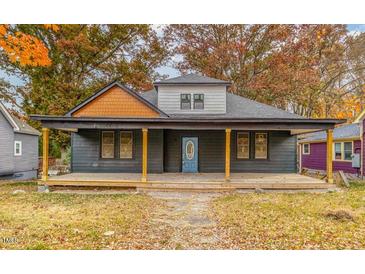Charming home featuring a covered front porch and a beautifully painted blue front door, perfect for welcoming guests at 210 N Driver St, Durham, NC 27703