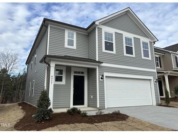 Two-story home with gray siding, white trim, and a two-car garage at 4937 S Trout Crest, Raleigh, NC 27604