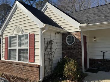 House exterior featuring vinyl siding, brick accents, and a red door at 6020 Newhall Rd, Durham, NC 27713