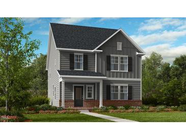Two-story home with gray siding, brick accents, and landscaping at 1264 Hardin Hill Ln, Knightdale, NC 27545