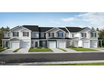 Front view of charming townhouses with attractive landscaping at 136 Parker Ln, Mebane, NC 27302