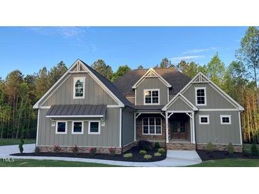 Charming home showcasing a blend of traditional and modern architecture, complete with meticulously maintained landscaping at 3913 Cedar Knolls # 7, Youngsville, NC 27596