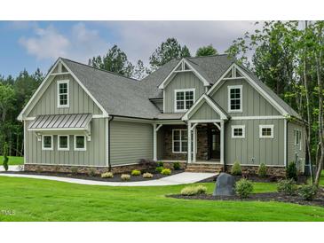 Charming exterior view of a home with gray siding, stone accents, manicured lawn and walkway at 3913 Cedar Knolls # 7, Youngsville, NC 27596