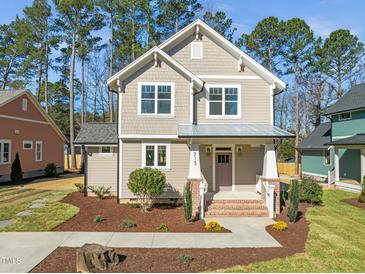 Charming two-story home featuring a landscaped yard, craftsman architecture, and inviting front porch at 713 Heidelberg St, Durham, NC 27704