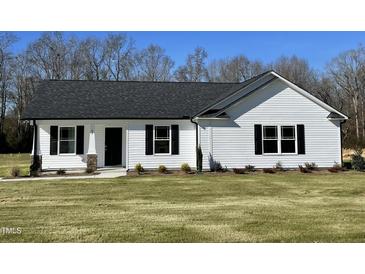 White house with black roof and landscaping at 83 Harvest Hills Ln, Dunn, NC 28334