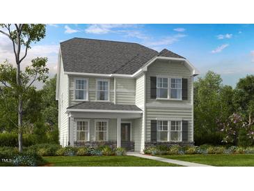 Two-story house with gray siding, stone accents, and a landscaped lawn at 1224 Hardin Hill Ln, Knightdale, NC 27545