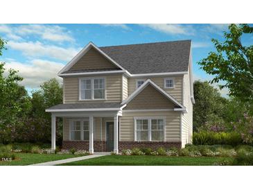 Two-story home with brick and siding, featuring a welcoming front porch at 1228 Hardin Hill Ln, Knightdale, NC 27545