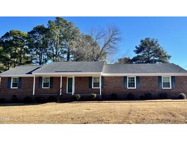 Brick ranch house with a spacious lawn and mature trees at 1641 Bridgedale Dr, Rocky Mount, NC 27803