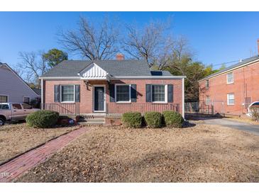 Brick home with a charming front porch and well-maintained landscaping at 210 Earl St, Rocky Mount, NC 27804