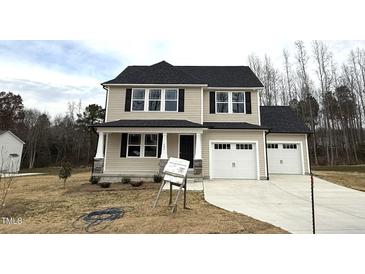 Two-story house with a two-car garage and landscaping at 262 Starry Sky Dr, Benson, NC 27504